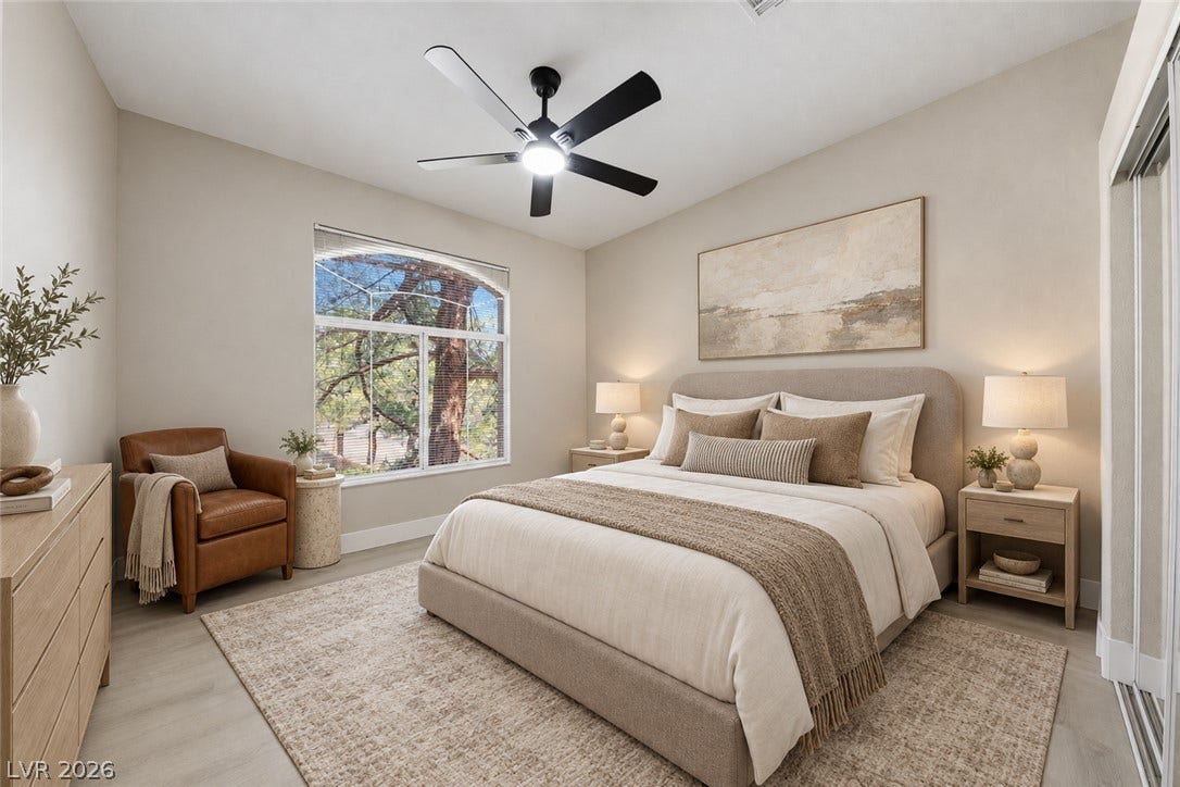 104 Lemon Glaze Street, #204, Las Vegas, NV 89145 A spacious arched window filters natural light onto the light wood floors.
