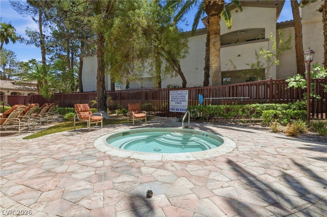 104 Lemon Glaze Street, #204, Las Vegas, NV 89145 An inviting in-ground spa sits surrounded by stone pavers and lush mature trees.