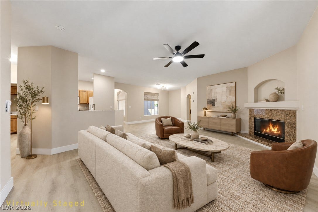 104 Lemon Glaze Street, #204, Las Vegas, NV 89145 An inviting stone fireplace serves as the centerpiece of this open-concept main living area.
