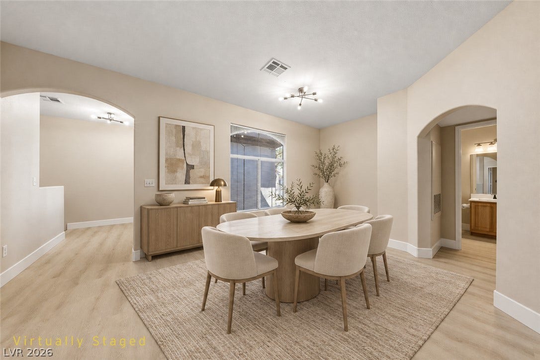 104 Lemon Glaze Street, #204, Las Vegas, NV 89145 Elegant arched transitions and smooth wood-look flooring define this welcoming dining area.