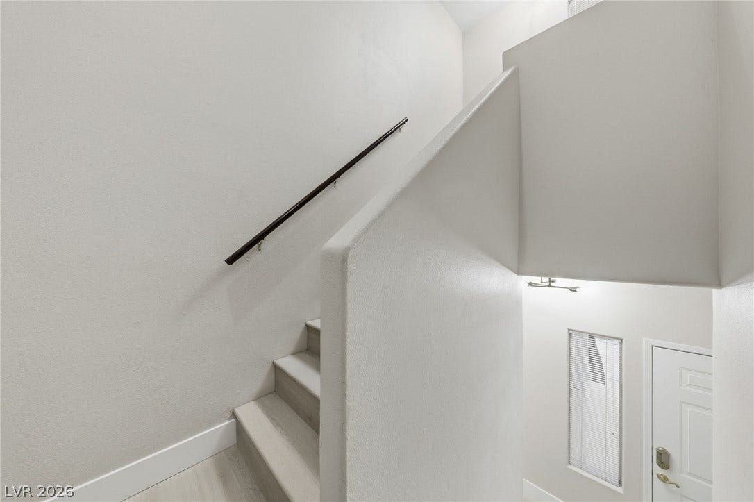 104 Lemon Glaze Street, #204, Las Vegas, NV 89145 Clean lines and a minimalist handrail define this modern, multi-level staircase entry.