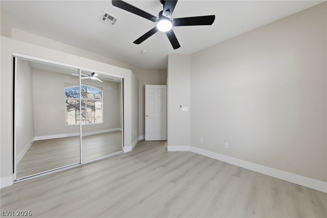 104 Lemon Glaze Street, #204, Las Vegas, NV 89145 Smooth wood-style flooring and mirrored closet doors enhance the clean lines of this bedroom.