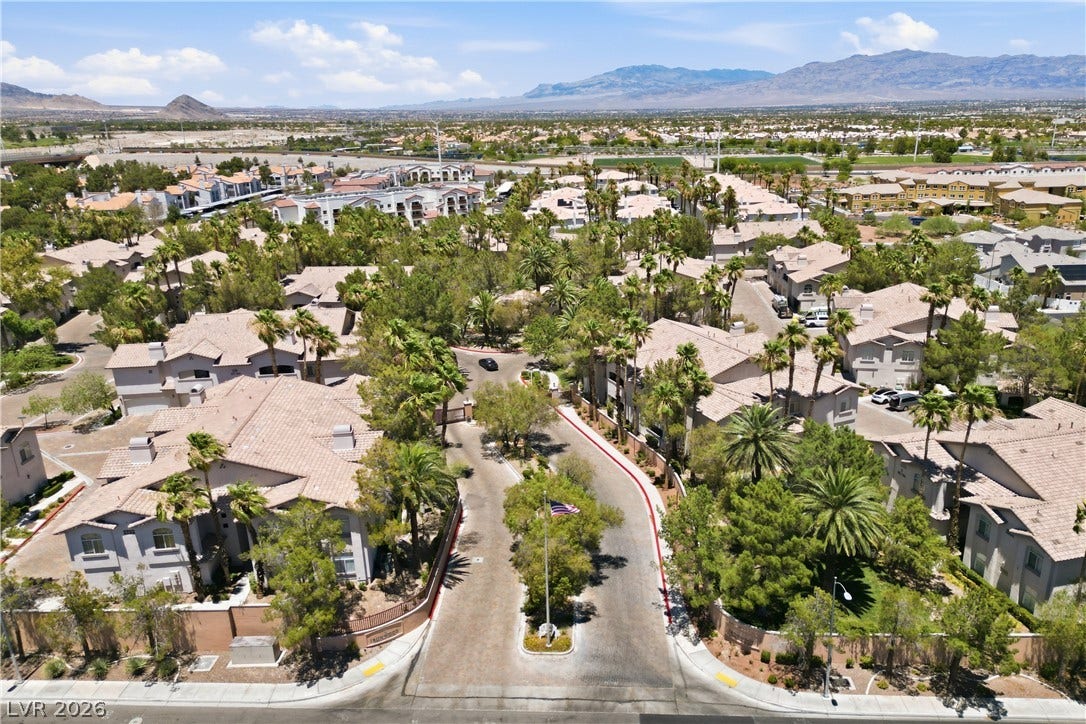 104 Lemon Glaze Street, #204, Las Vegas, NV 89145 Aerial view showcasing a gated residential enclave framed by desert mountain vistas.