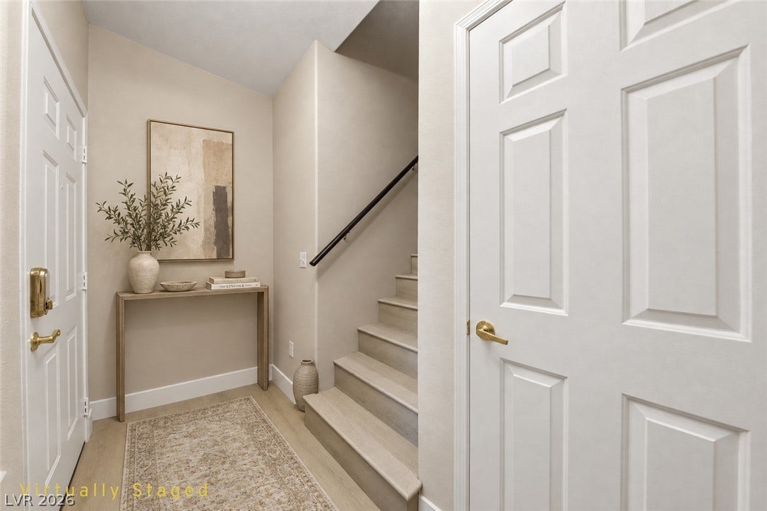 104 Lemon Glaze Street, #204, Las Vegas, NV 89145 An inviting entryway leads past a classic staircase to the upper level.