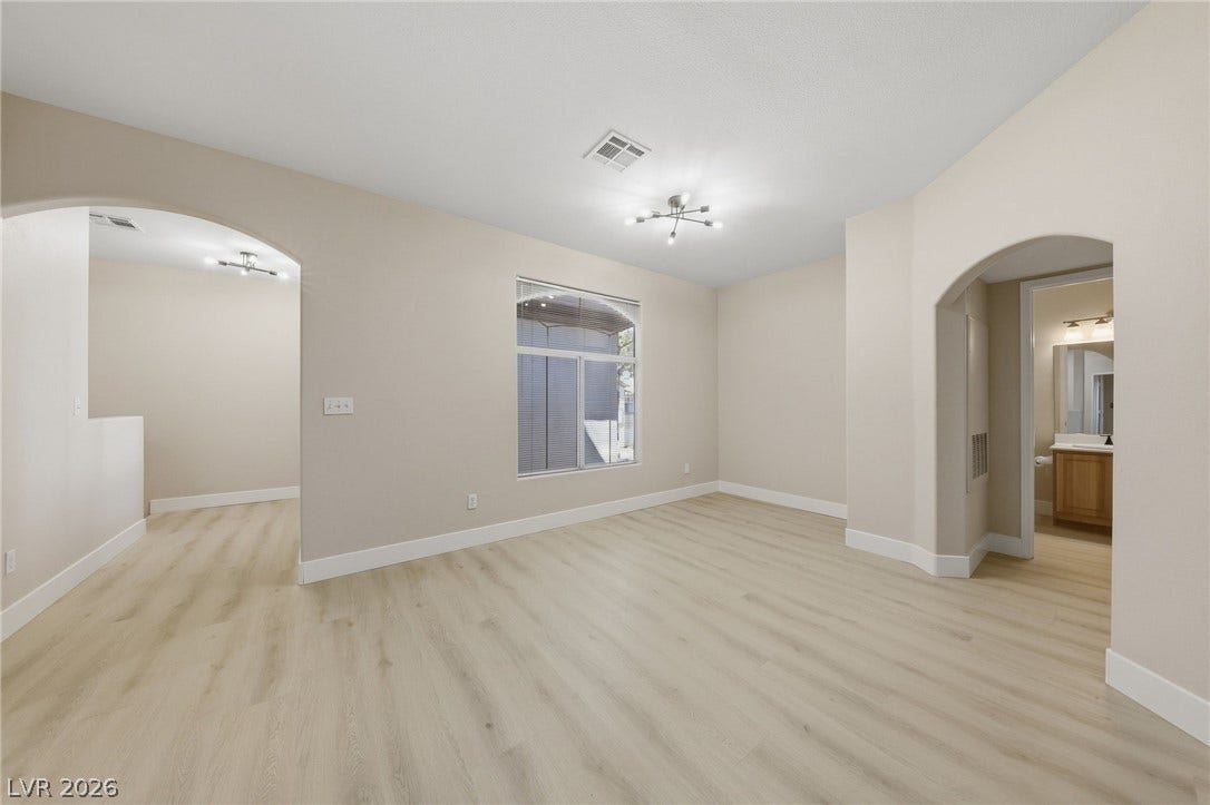 104 Lemon Glaze Street, #204, Las Vegas, NV 89145 Smooth archways and clean wood-plank flooring define this versatile open living space.