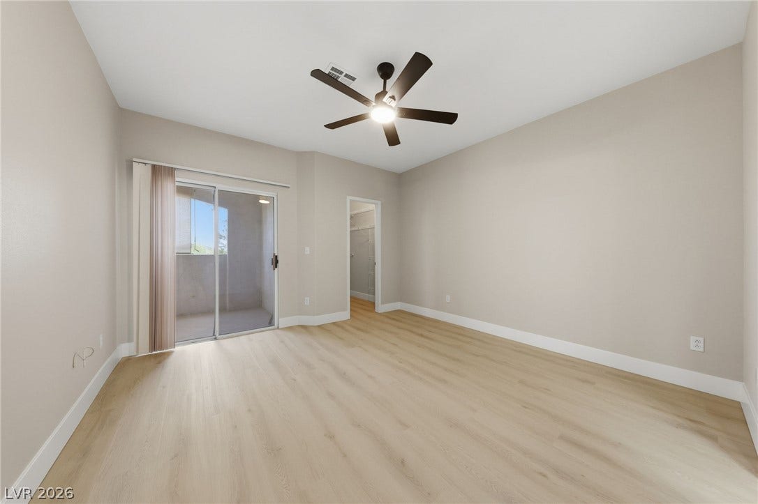 104 Lemon Glaze Street, #204, Las Vegas, NV 89145 Sliding glass doors open to a private outdoor space from this inviting bedroom.