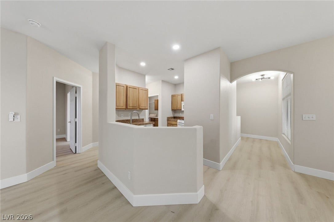 104 Lemon Glaze Street, #204, Las Vegas, NV 89145 Clean lines and smooth vinyl plank flooring define this functional open-concept living and kitchen area.