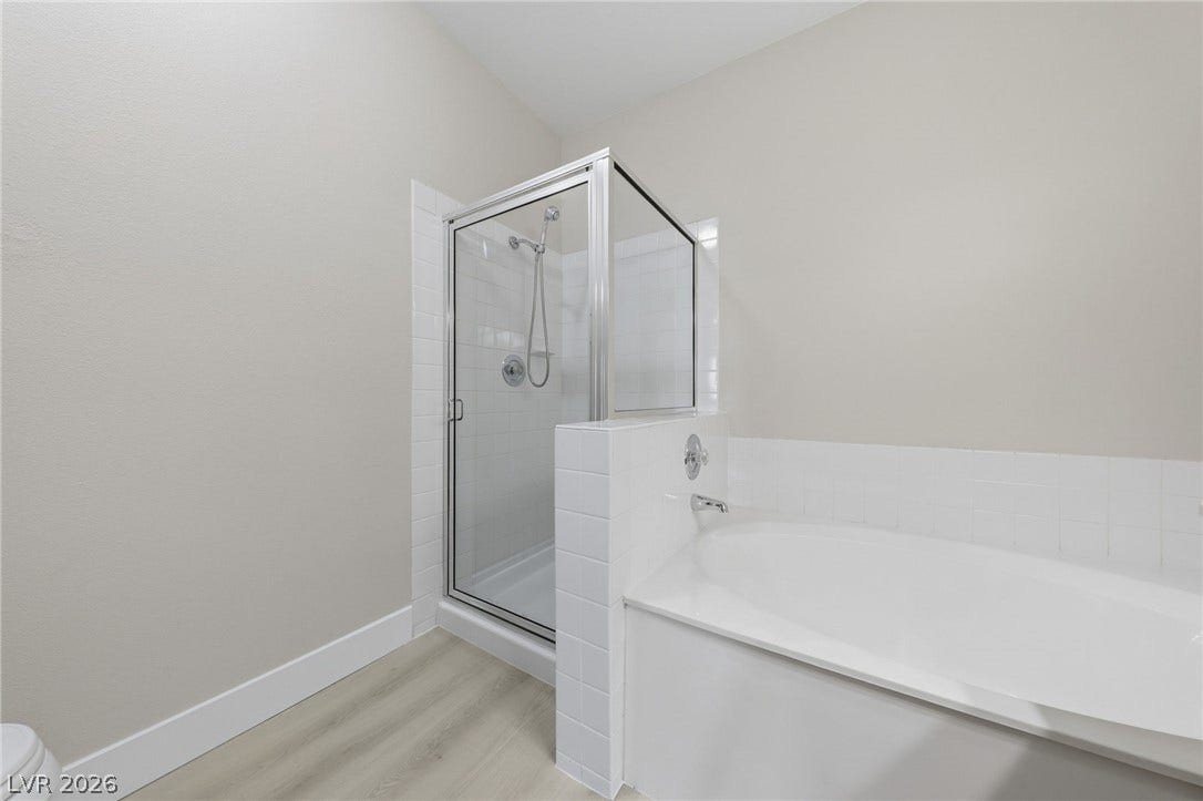 104 Lemon Glaze Street, #204, Las Vegas, NV 89145 Clean lines define this modern bathroom featuring a separate shower and soaking tub.