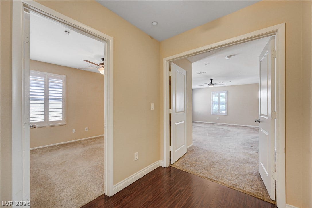 2088 Artistic Flair Walk, Henderson, NV 89044 Double doors open to spacious carpeted rooms branching from a polished wood hallway.
