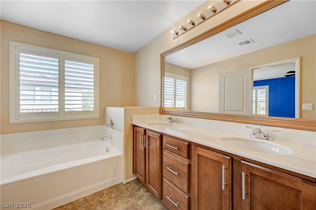 2088 Artistic Flair Walk, Henderson, NV 89044 Double vanities and a soaking tub complete this functional bathroom space.