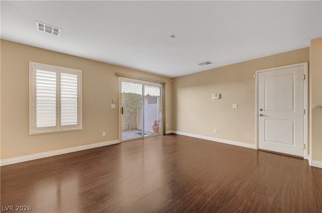 2088 Artistic Flair Walk, Henderson, NV 89044 Laminate wood floors and a sliding glass door define this versatile living space.