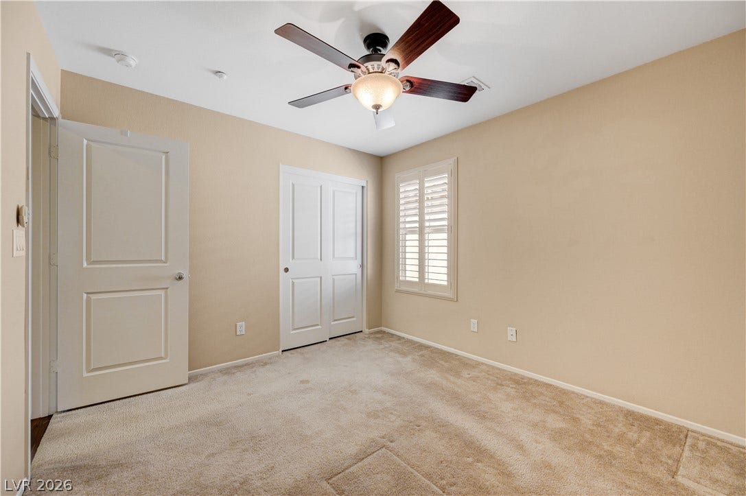 2088 Artistic Flair Walk, Henderson, NV 89044 Upstairs bedroom with carpeting and plantation shutters define this versatile secondary bedroom space.