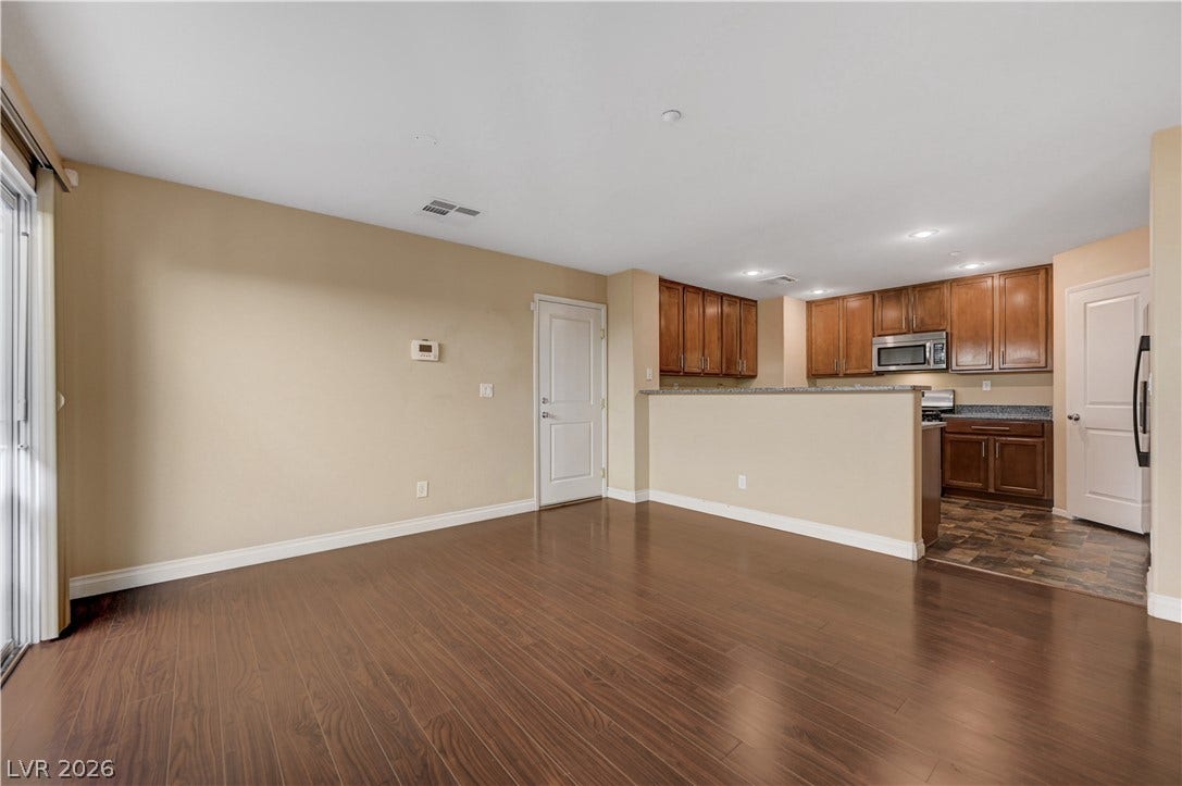 2088 Artistic Flair Walk, Henderson, NV 89044 Polished laminate wood floors anchor this open-concept space leading into a classic kitchen area.