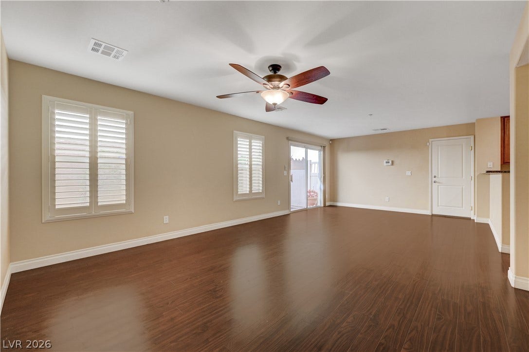 2088 Artistic Flair Walk, Henderson, NV 89044 Rich laminate wood floors and clean window shutters define this versatile open living space.
