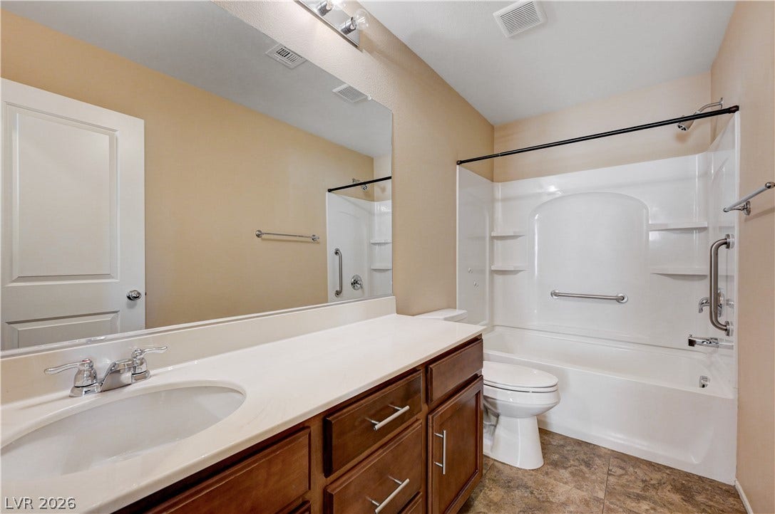 2088 Artistic Flair Walk, Henderson, NV 89044 Warm wood cabinetry and durable tiled floors define this clean guest bathroom space.