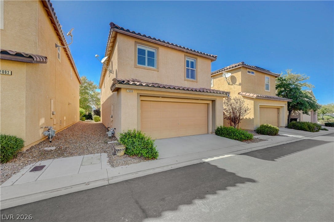 2088 Artistic Flair Walk, Henderson, NV 89044 Mediterranean-style stucco exterior presents clean architectural lines and an attached two-car garage.