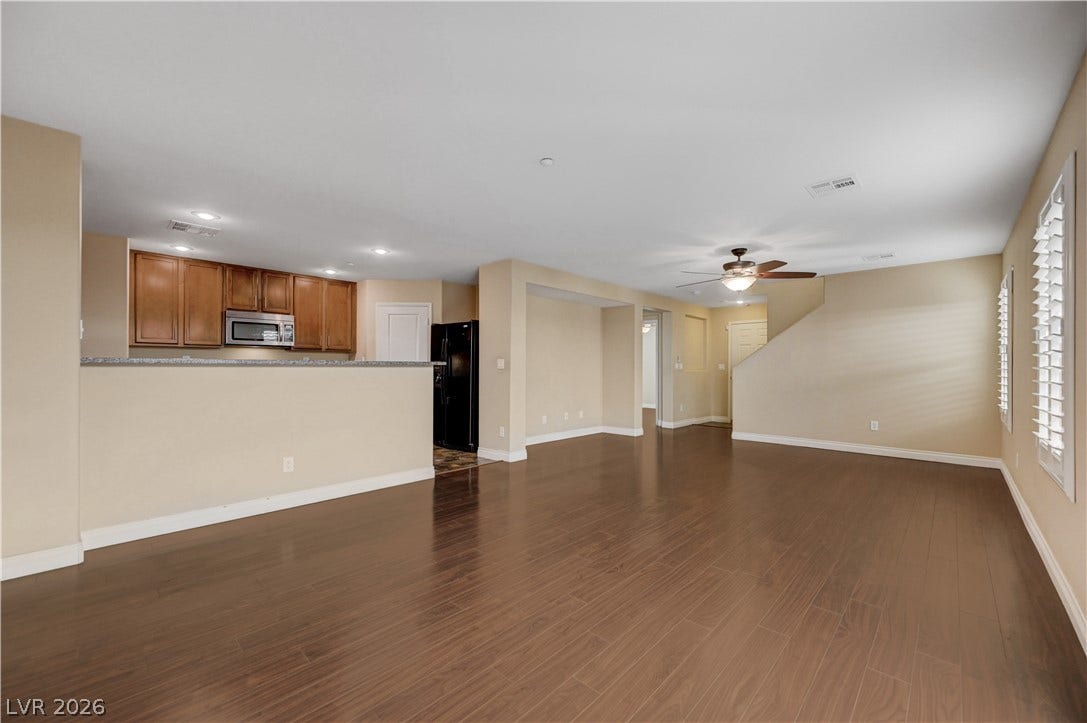 2088 Artistic Flair Walk, Henderson, NV 89044 Polished laminate wood floors flow through this open-concept main level seamlessly connecting the living spaces.