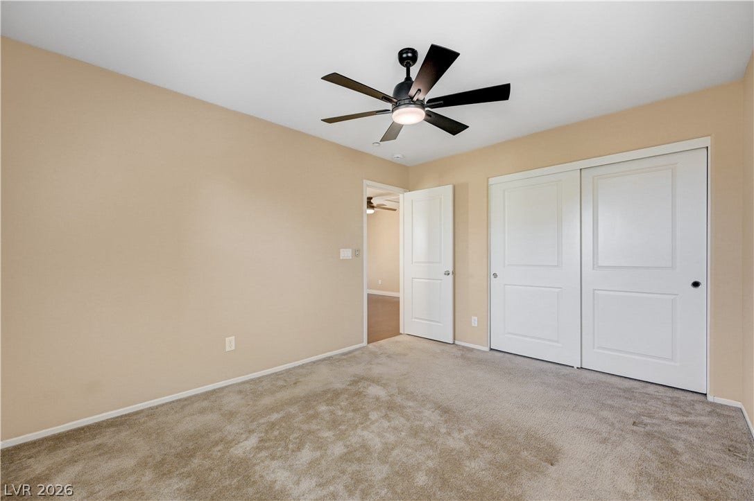 2088 Artistic Flair Walk, Henderson, NV 89044 Plush carpeting and integrated sliding closet doors define this comfortable bedroom space.