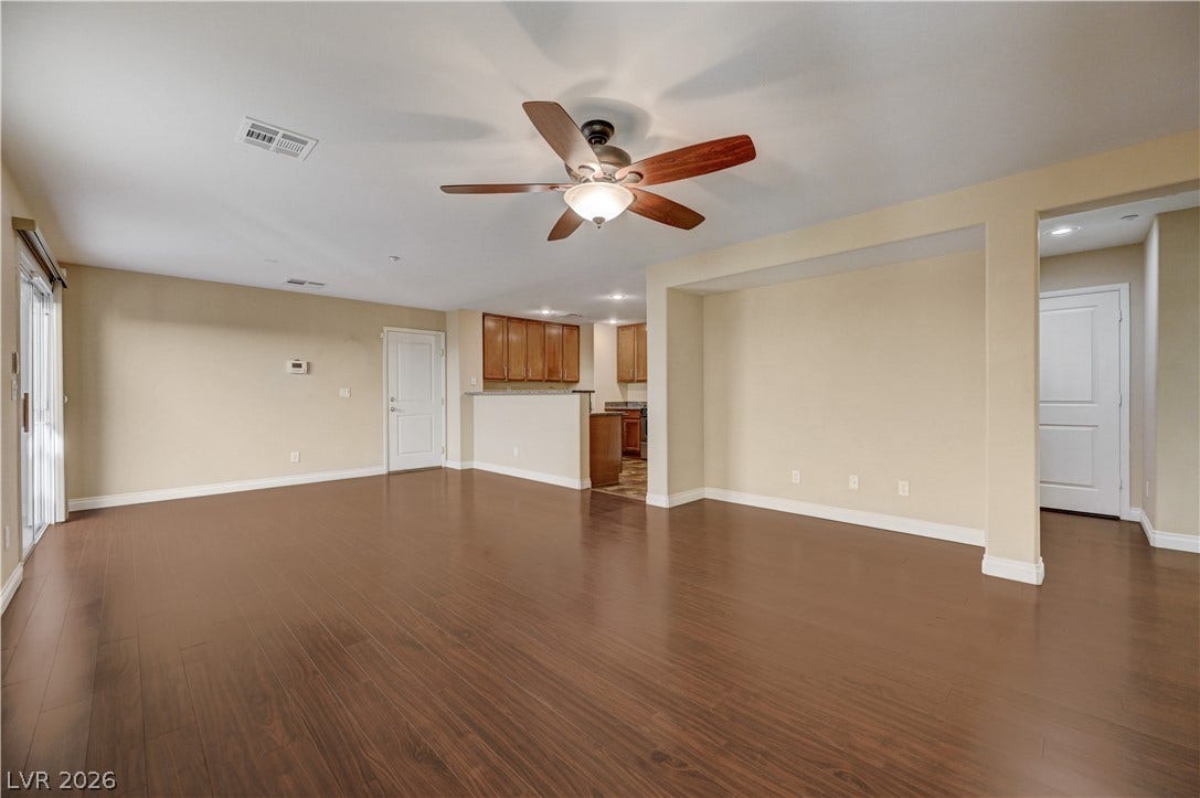 2088 Artistic Flair Walk, Henderson, NV 89044 Rich laminate wood flooring spans this versatile open layout, connecting seamlessly to the nearby kitchen.