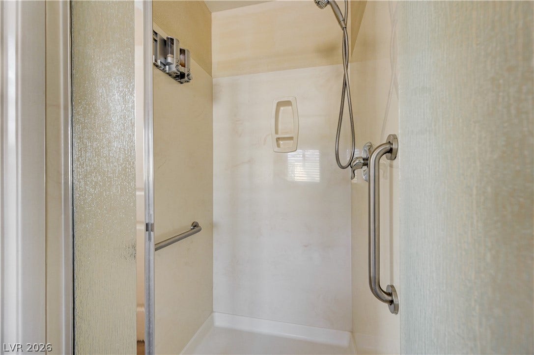 2088 Artistic Flair Walk, Henderson, NV 89044 Glass doors enclose a walk-in shower equipped with safety grab bars.