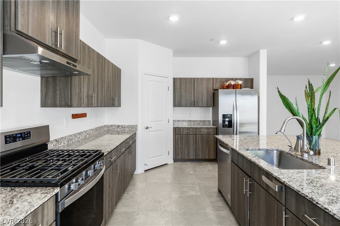 4429 Ginger Hills Avenue, Las Vegas, NV 89141 Modern cabinetry and granite countertops frame a functional layout complete with stainless steel appliances.