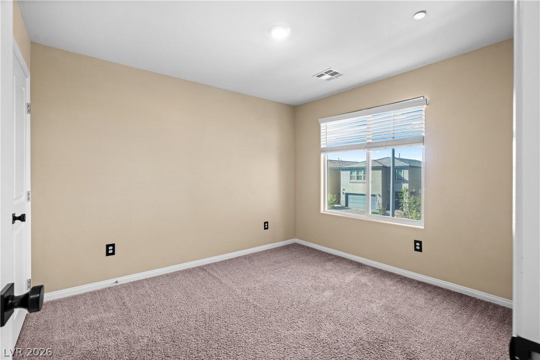 4429 Ginger Hills Avenue, Las Vegas, NV 89141 Plush carpeting and recessed lighting create a comfortable atmosphere in this versatile secondary bedroom.