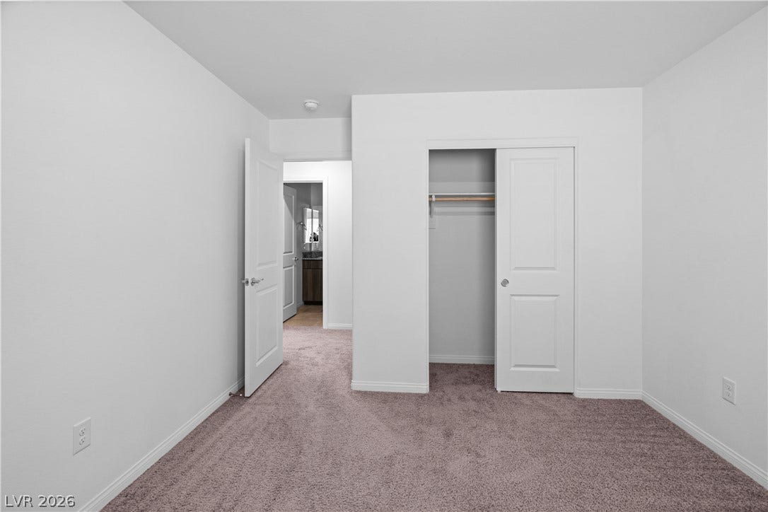 4429 Ginger Hills Avenue, Las Vegas, NV 89141 Soft carpeting pairs with neutral walls in this minimalist, versatile bedroom space.