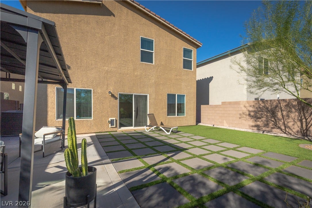 4429 Ginger Hills Avenue, Las Vegas, NV 89141 Geometric pavers and synthetic turf create a clean, low-maintenance landscape design in this backyard oasis.