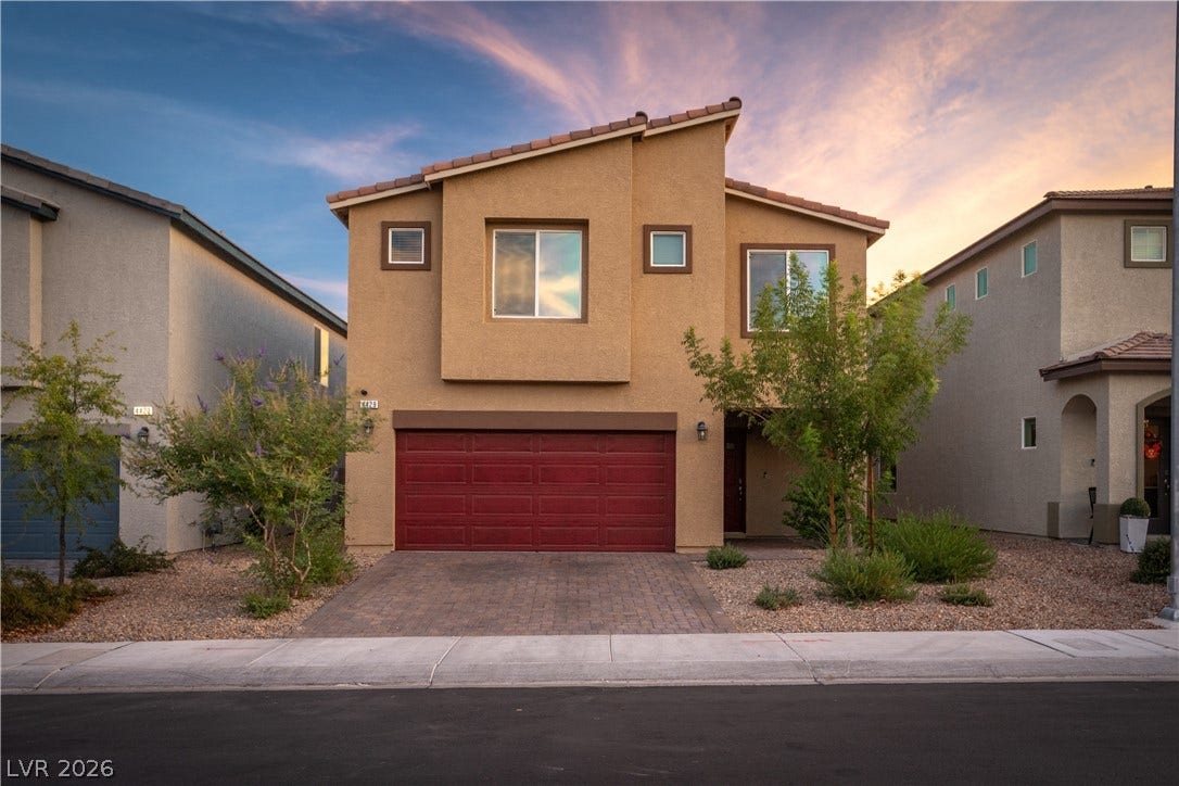 4429 Ginger Hills Avenue, Las Vegas, NV 89141 A classic stucco exterior features a paver driveway, front-facing garage, and desert-inspired plantings.