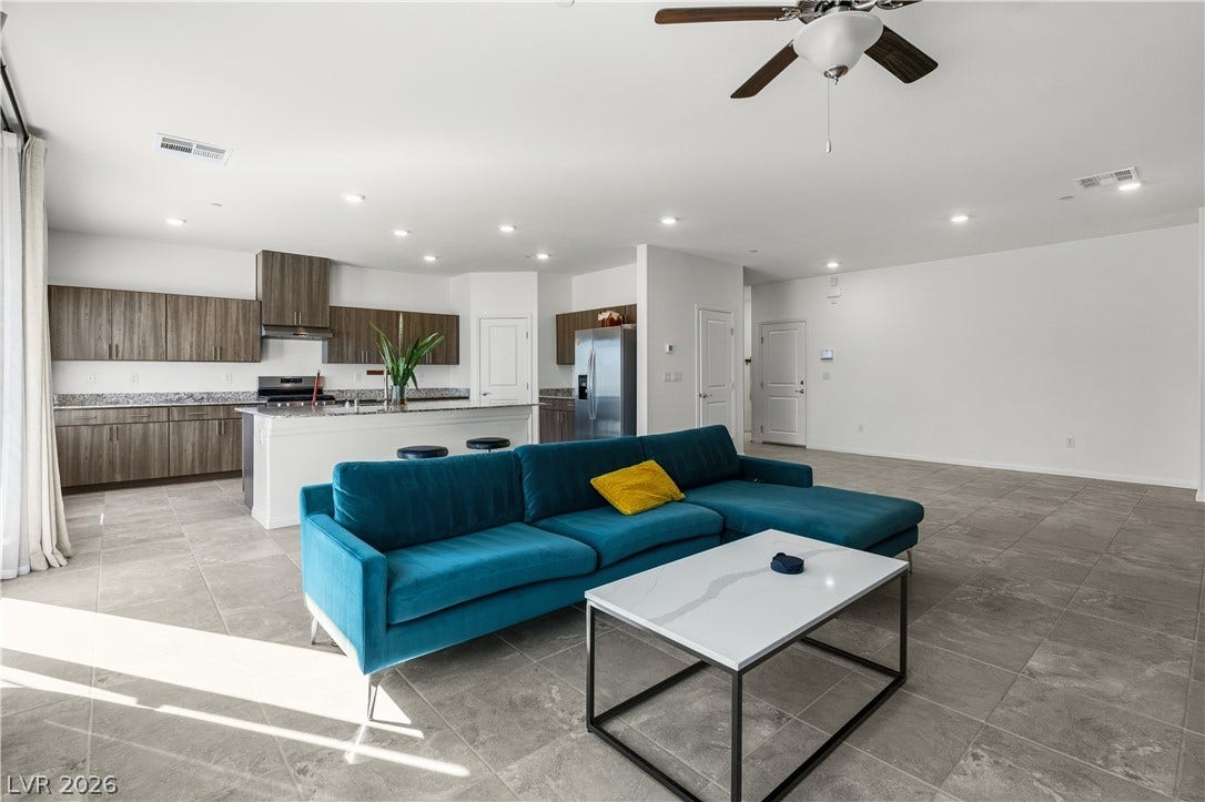 4429 Ginger Hills Avenue, Las Vegas, NV 89141 An open floorplan seamlessly connects the airy living area to a modern kitchen with tiled flooring.
