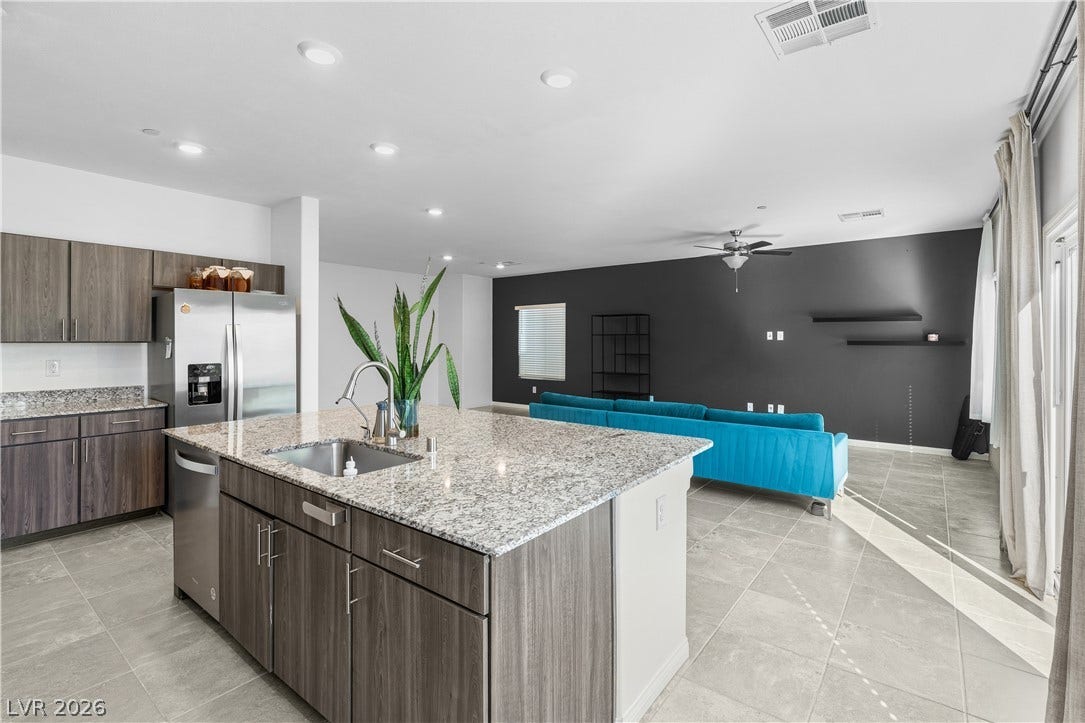 4429 Ginger Hills Avenue, Las Vegas, NV 89141 Polished tile floors and granite counters anchor this modern, open-concept living space.