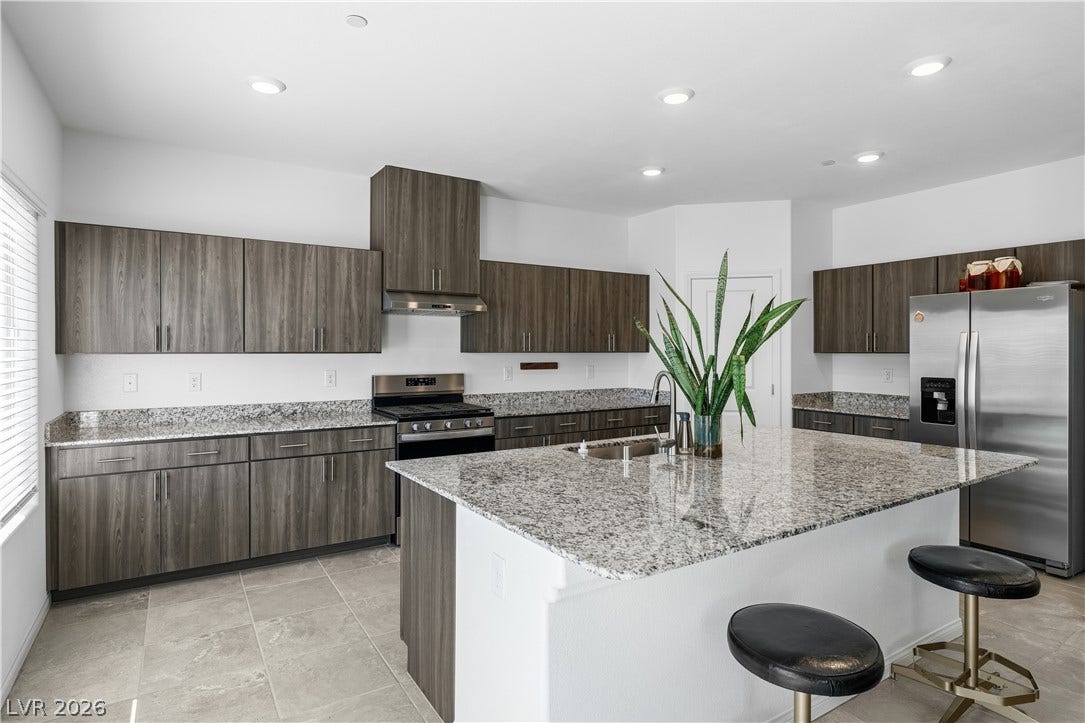 4429 Ginger Hills Avenue, Las Vegas, NV 89141 Polished granite countertops complement contemporary cabinetry and an expansive central island.