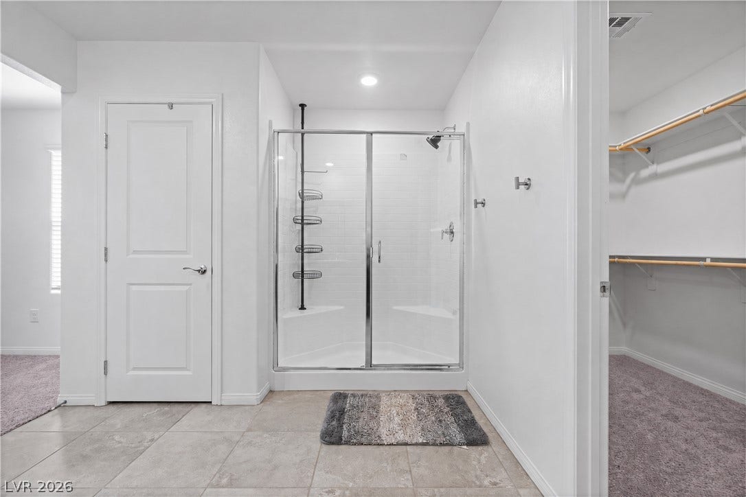 4429 Ginger Hills Avenue, Las Vegas, NV 89141 Clean tile flooring surrounds a glass-enclosed walk-in shower situated adjacent to a spacious closet.