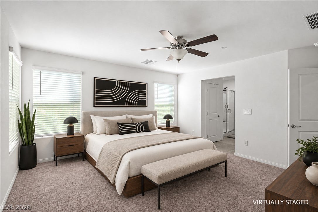 4429 Ginger Hills Avenue, Las Vegas, NV 89141 Generous natural light and plush carpeting define this serene bedroom with an adjoining bath.