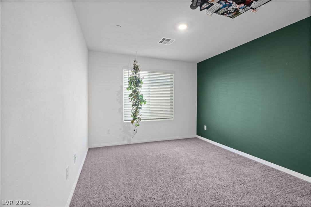 4429 Ginger Hills Avenue, Las Vegas, NV 89141 Recessed lighting and plush carpeting define this versatile secondary bedroom space.