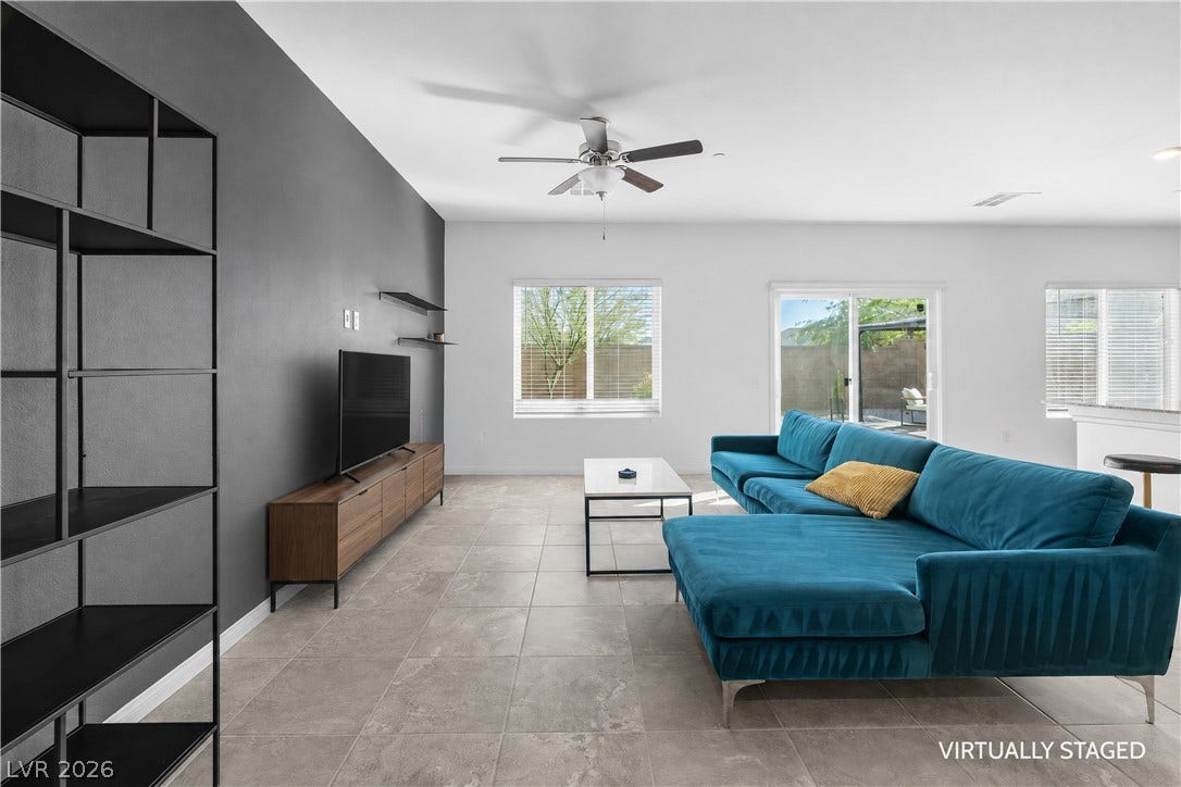 4429 Ginger Hills Avenue, Las Vegas, NV 89141 Gleaming tile floors and large windows define this open-concept living area.