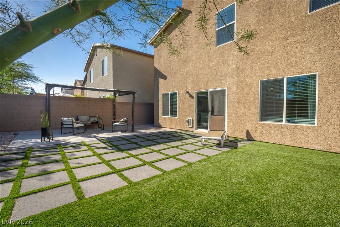 4429 Ginger Hills Avenue, Las Vegas, NV 89141 An inviting backyard patio features concrete pavers set in lush green turf.