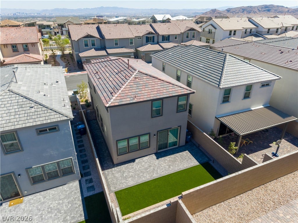 An aerial perspective showcases the tidy backyard layout and tile roof structure of this home.