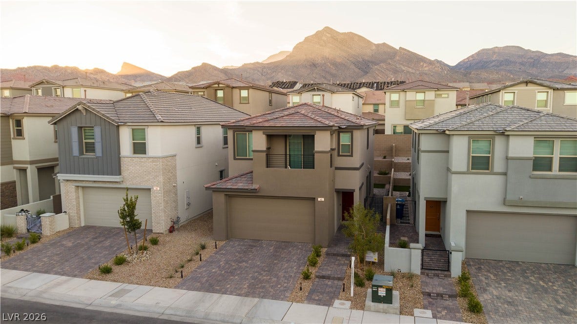 Striking desert mountains create a dramatic backdrop for these modern multi-level suburban residences.