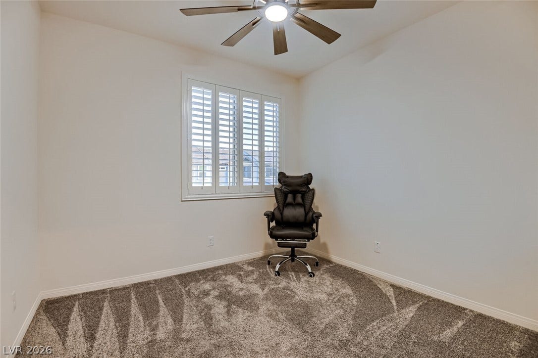 Plush carpeting and classic plantation shutters define this versatile secondary space.