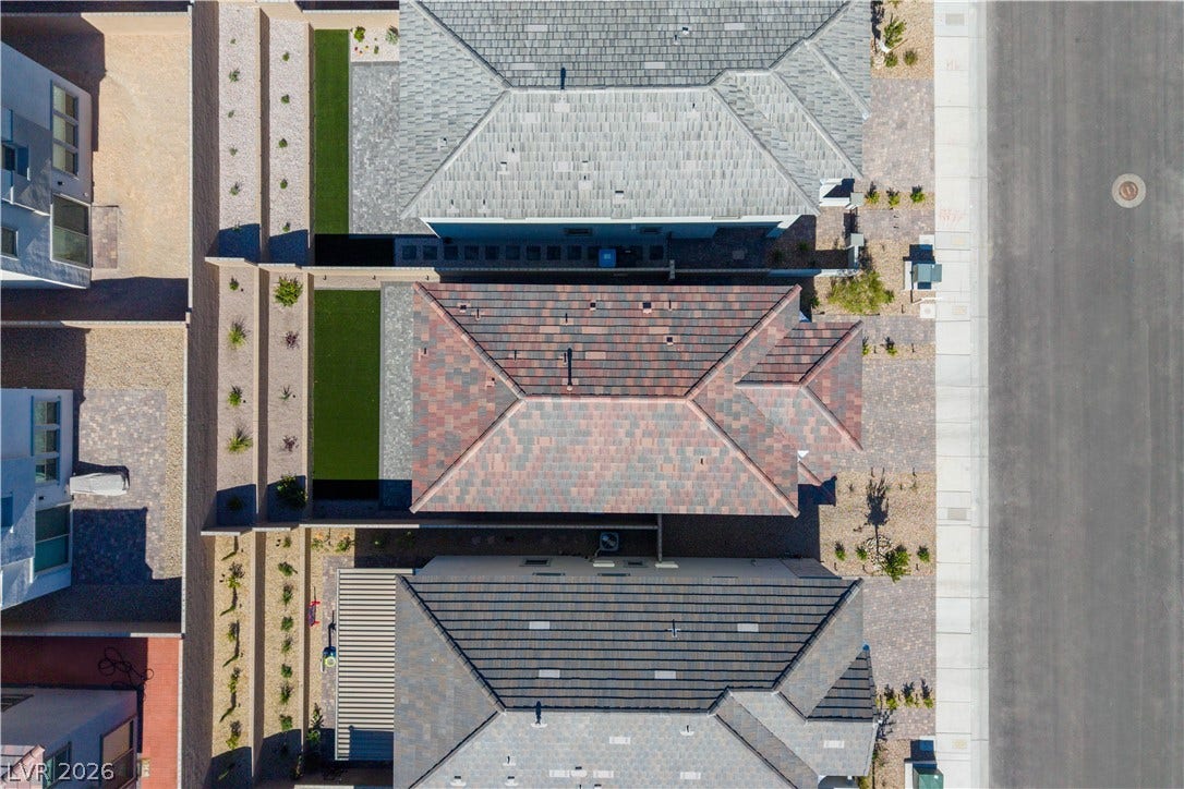 An aerial perspective showcases the structured neighborhood layout and modern tile rooflines.