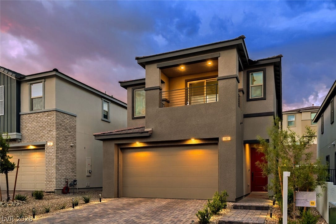 Clean lines and a private upper balcony define this modern multi-level exterior.