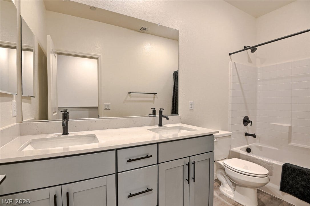Clean lines and a spacious dual vanity define this modern bathroom space.