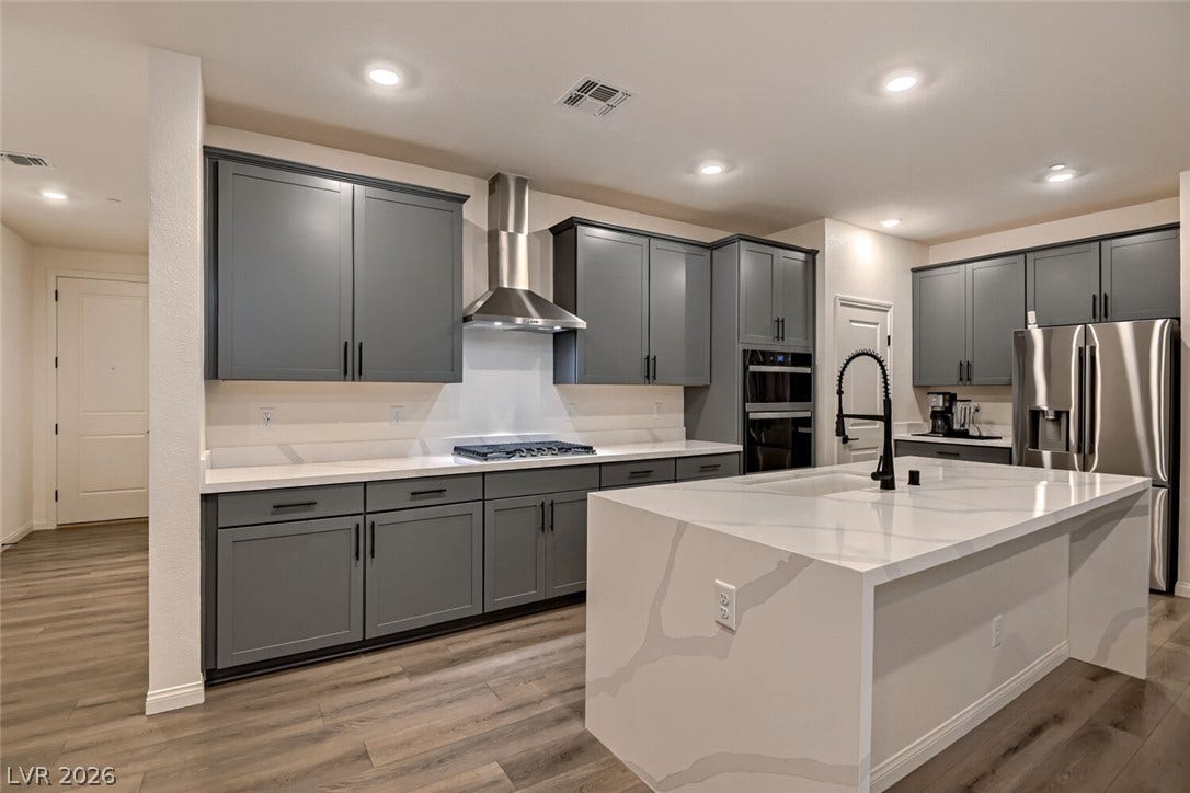 Gleaming stone countertops and modern cabinetry define this spacious, open culinary workspace.