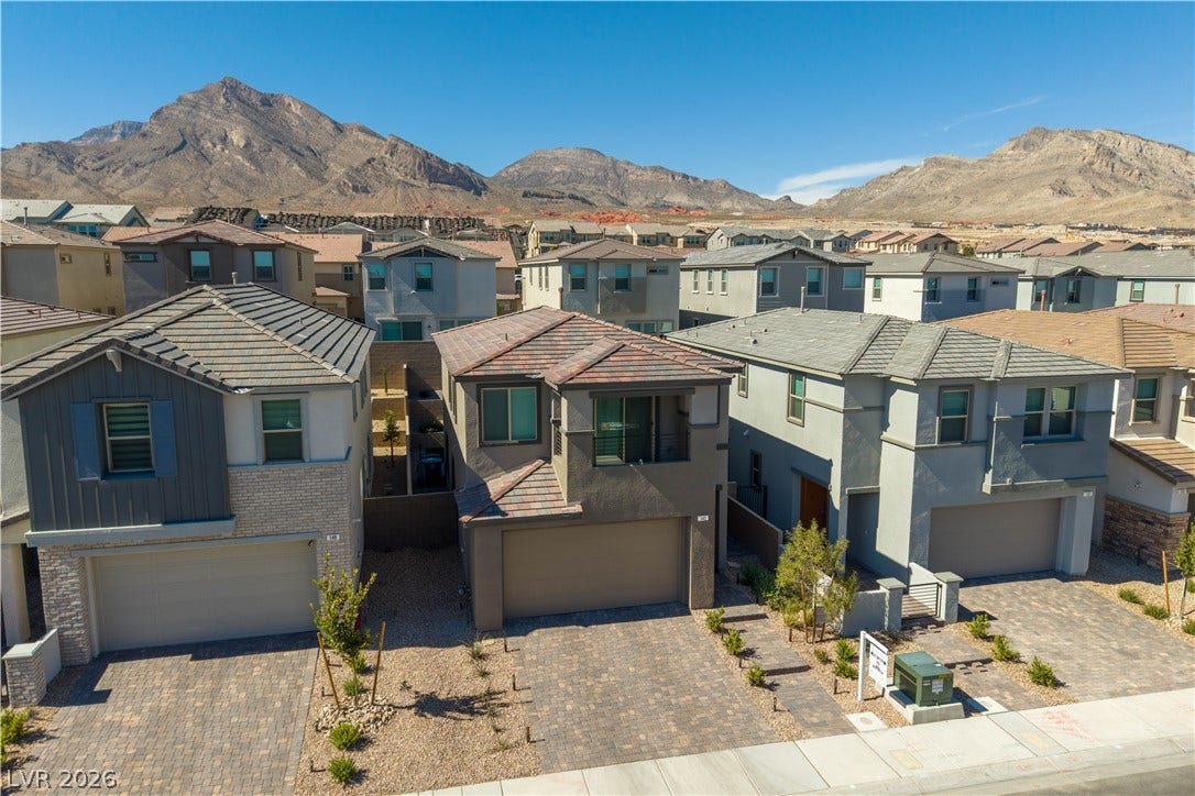 Striking desert peaks rise majestically behind this collection of modern two-story residences.