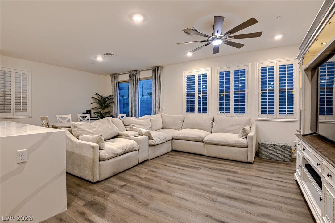 Gleaming wood-look floors complement the light-filled layout.