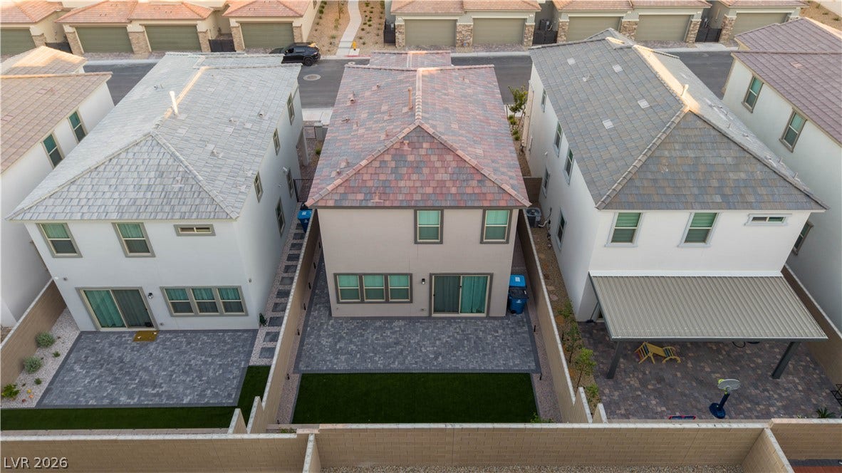 Neat paved patios and low-maintenance yards define these contemporary multi-level homes.