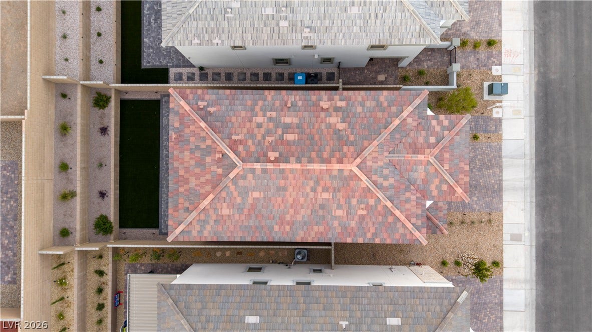 A top-down aerial view highlights the clean lines of a multi-colored tile roof.