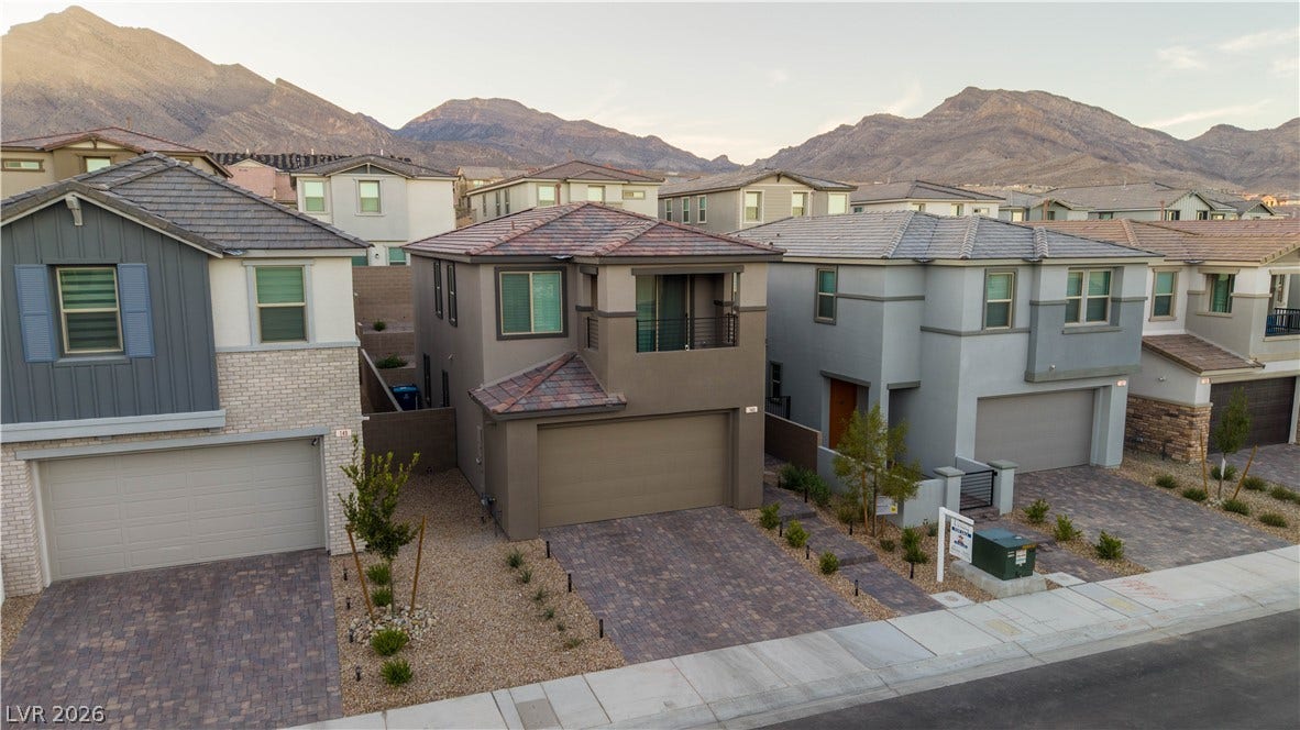 Nestled against a dramatic mountain backdrop, this contemporary multi-level home features a private upper balcony.
