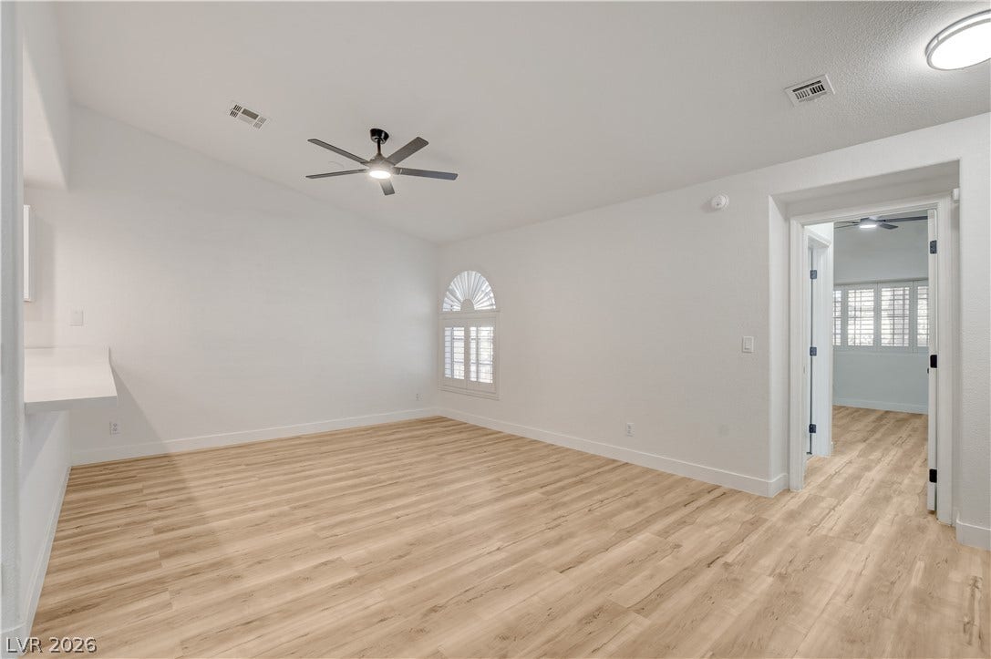 3676 Renovah Street, #205, Las Vegas, NV 89129 Warm wood flooring and clean white walls create a versatile canvas for any layout.